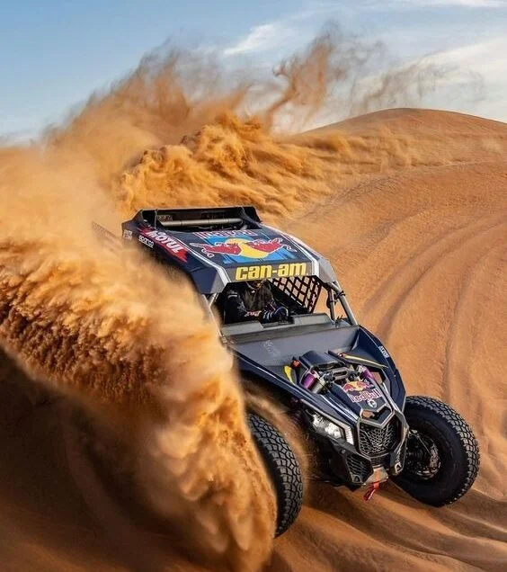 Dune buggy speeding across golden sand dunes in Dubai desert adventure
